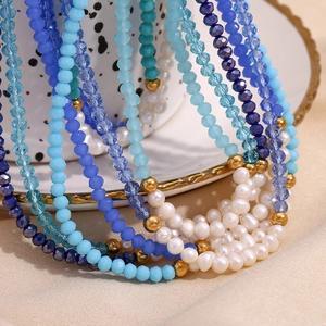Detailed shot of blue crystal beads and white freshwater pearls on a beaded necklace