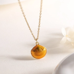 Chic 18K gold plated necklace featuring an orange shell pendant with enamel texture