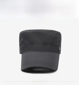 Macro detail of dark grey cadet cap with laser-cut breathability holes and metal logo