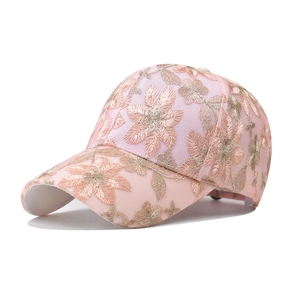 Detail of pink lace baseball cap with intricate gold flower embroidery texture