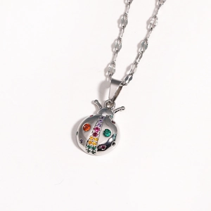 Silver ladybug necklace with colorful crystals on a delicate chain in a studio shot