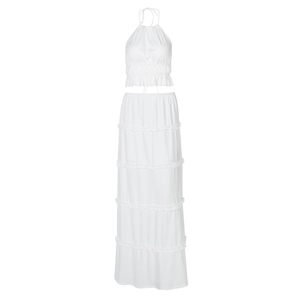 Detailed flat lay of white two-piece set featuring ruffled long skirt and crop top