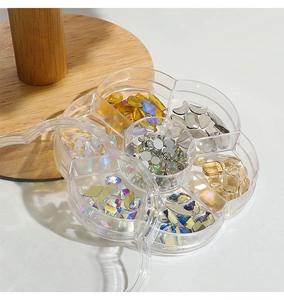 Detailed view of flower-shaped organizer box with mixed aurora nail art rhinestones and gems