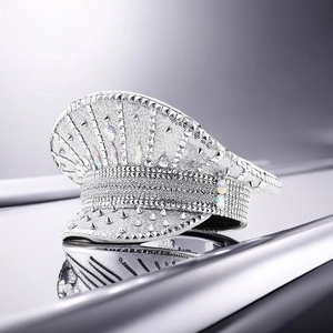 Detail of silver sequined captain hat featuring metallic studs and iridescent rhinestones