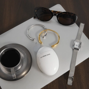 Minimalist gold and silver irregular stainless steel open bracelets on a laptop