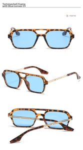Close-up of tortoise frame sunglasses with gold metal temples and blue lenses