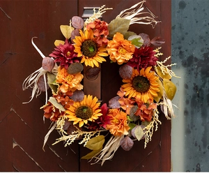 Close-up of a 45cm autumn sunflower wreath with dahlias and grain hanging on a wooden door