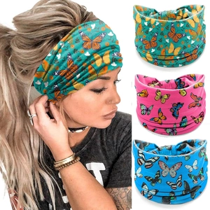Detail view of elastic yoga headbands featuring colorful butterfly prints and knotted design