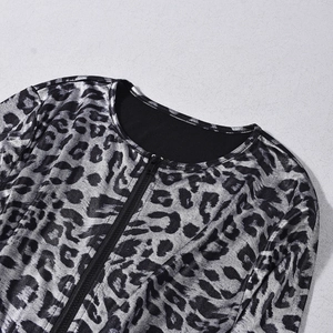 Detail of silver leopard print V-neck jumpsuit with a smooth metallic finish and zipper