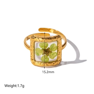 Detail view of 18K gold plated ring with green dried flower resin and 15.2mm dimensions