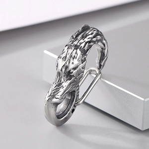 Macro view of vintage silver steel dragon head lobster clasp with spring mechanism