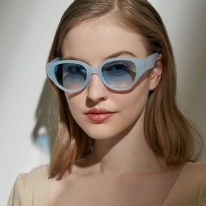 Fashionable blue cat-eye sunglasses featuring gradient lenses and a stylish translucent frame