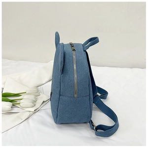 Close-up of blue denim mini backpack featuring cute rabbit ears and durable metal zipper