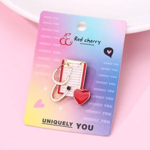 Macro detail of a medical brooch with stethoscope and red heart on display card