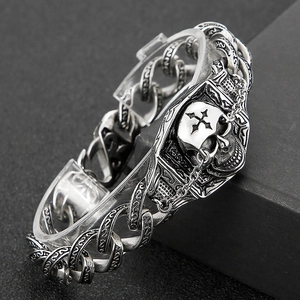 Macro shot of vintage silver skull bracelet with engraved heavy metal chain links