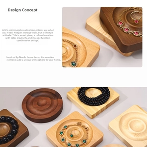 Detail of wooden jewelry tray showing tiered grooves for bracelets and necklaces