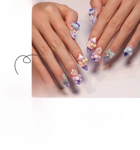 Detail of 3D bear and baby bottle charms on light purple stiletto press-on nails