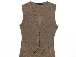 Detail of V-neck brown wool vest showing fine fabric texture and metallic buttons