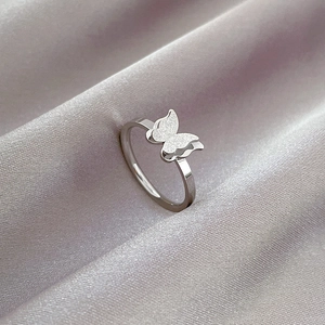 Detail of silver butterfly ring featuring double-layered wings with matte and polished finish