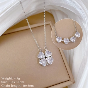 Detail view of silver clover necklace showing foldable heart design and product dimensions
