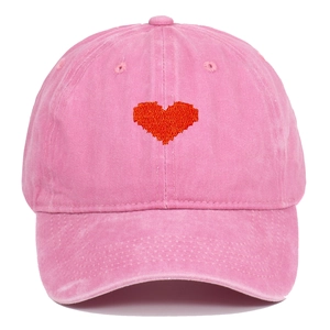 Close-up of pink washed cotton baseball cap featuring red pixelated heart embroidery