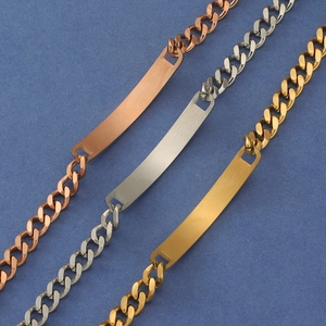 Cuban link ID bracelets in gold silver and rose gold finishes on blue background