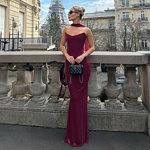 Detail of burgundy tube maxi dress with pleated fabric and matching scarf near Eiffel Tower