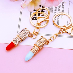 Sparkling rhinestone lipstick keychains in red and blue colors with gold hardware