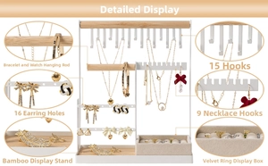Detail view of white metal jewelry rack with wood bars and velvet ring organizer