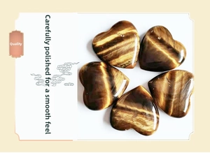 Macro view of five heart-shaped Tiger Eye stones with polished silky finish and cat-eye effect