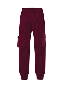 Detail view of burgundy quilted square texture and elastic waistband on cargo pants