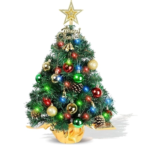 Close-up of decorated mini Christmas tree with LED lights, pinecones and ornaments