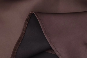 Detailed macro view of chocolate brown satin dress fabric with fine stitching and silk texture