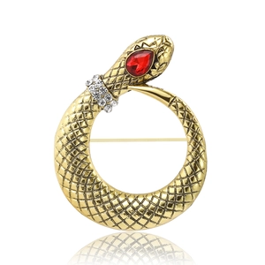 Elegant gold snake brooch with red crystal head and clear rhinestones on white background