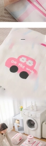 Close-up of fine mesh laundry bag featuring pink zippers and cartoon car patterns