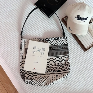 Detail showing bohemian canvas tote with geometric prints and slim leather strap