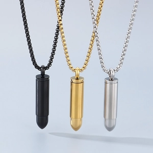 Three minimalist stainless steel bullet pendants in black, gold, and silver finishes