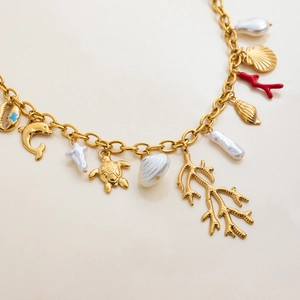 Gold-plated stainless steel ocean charm necklace with sea turtle, dolphin and pearl charms