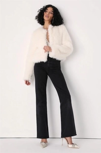 Detailed texture of white faux fur coat featuring soft plush material and round neck design