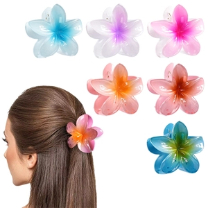 Detail view showing six colorful matte tropical frangipani hair clips and model styling