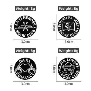 Detail view of round book club enamel pins with dark romance motifs and 3cm diameter