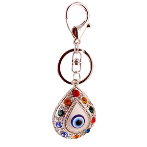 Silver evil eye keychain with blue crystal rhinestones on a minimalist white background