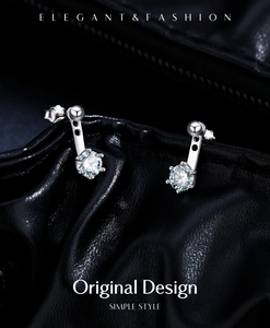 Detailed view of silver s925 stud earrings with sparkling round teal moissanite stones
