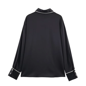 Women's black satin long sleeve shirt with white contrast piping, minimalist back view