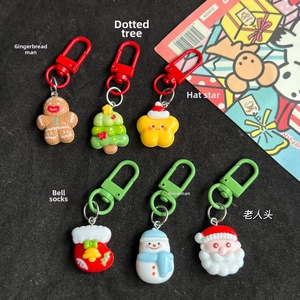 Close-up of resin Christmas charms including gingerbread man, snowmen, and star patterns