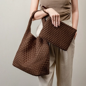 Brown hand-woven tote bag with matching pouch shown in a stylish streetwear look