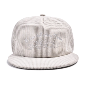 Detailed close-up of corduroy texture and mountain embroidery on flat brim baseball cap