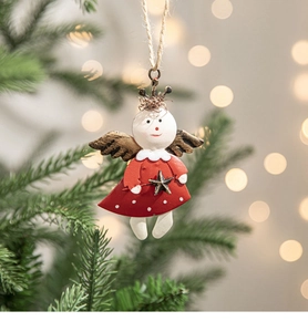 Detailed view of a red metal angel Christmas ornament hanging on a festive tree branch
