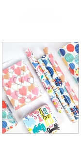 Detail view of birthday gift wrapping paper rolls with colorful animal and balloon patterns