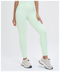 Detailed close-up of mint green high-waisted seamless yoga pants with knit texture
